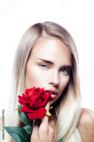Beautiful attractive sensual young model woman beauty close-up face, red rose flower near lips. Perfect skin, blonde hairstyle, looking at camera. Isolated. White background © beauty_objects