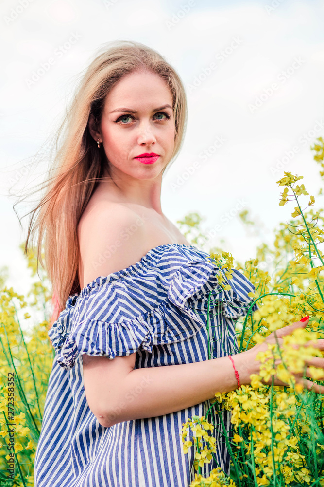 Beautiful young blonde girl poses for the camera in rape