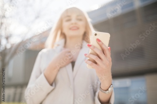 Portrait of a young girl holding a mobile phone. Free Download Portrait of a young girl holding a mobile phone. - GFXLoad