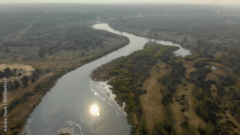 A picturesque panorama of nature, winding river in which the sun is reflected. Shine of water in the river A picturesque panorama of nature, winding river in which the sun is reflected. Shine of water in the river
