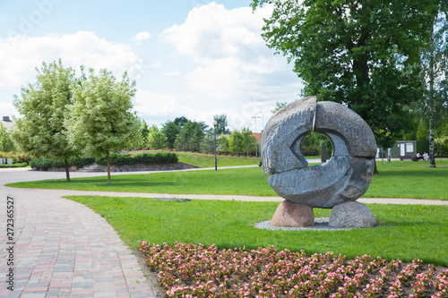 City Jelgava, Latvian Republic. City park with sculpture and flowers. Walking paths and trees. Jun 9. 2019. Travel photo.