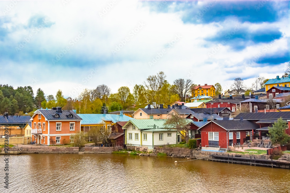 Scenic view of the Finnish city of Parvoo. Neat outbuildings. Spring nature. Multicolored buildings along the city promenade.