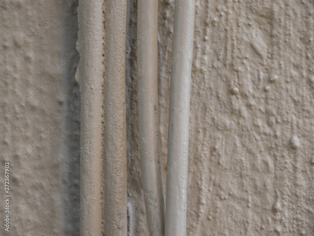 Fototapeta premium Cabling running down the side of a building image with copy space