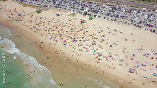 Crowded public beach with colourful umbrellas, Aerial footage. photo