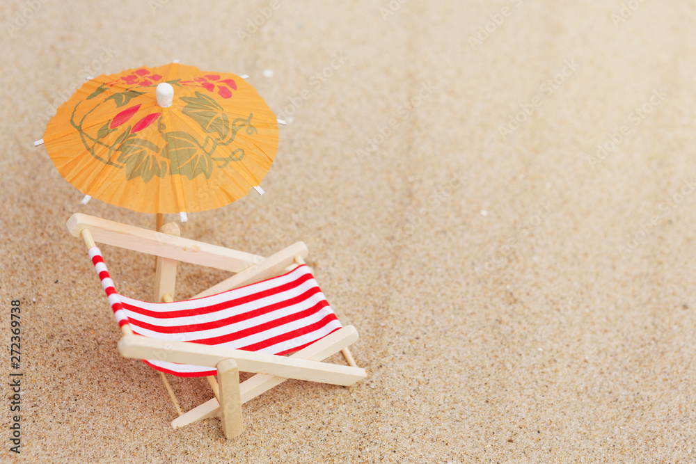 sun lounger and parasol stand on the sand, minimal concept of summer vacation sun lounger and parasol stand on the sand, minimal concept of summer vacation