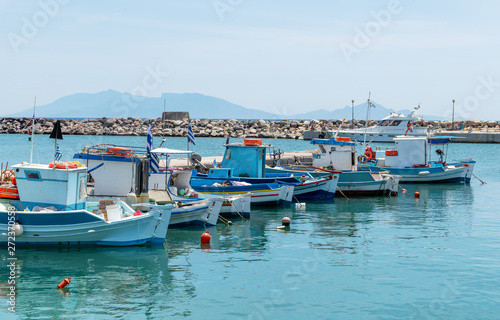 Boats in small Aegean sea port in Greece.