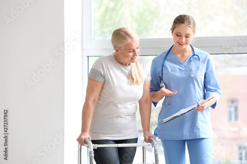 Medical assistant explaining mature woman her diagnosis in clinic