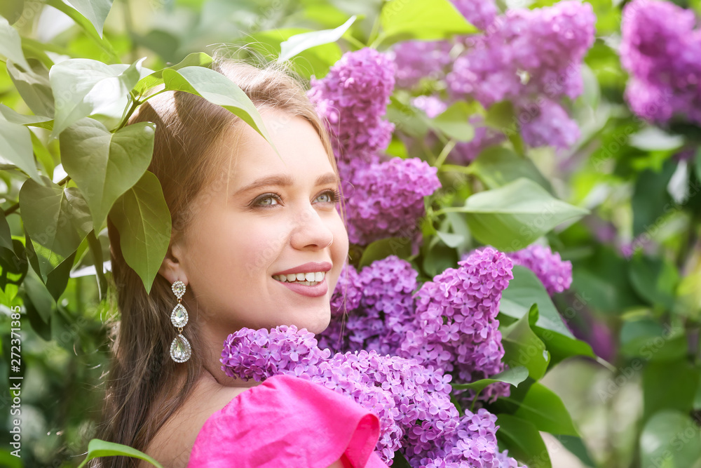 Beautiful young woman near blossoming lilac bush outdoors Beautiful young woman near blossoming lilac bush outdoors