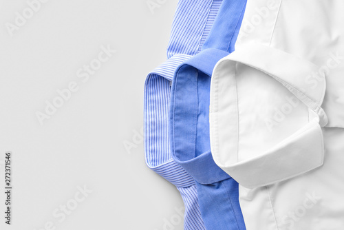 Shirts after dry-cleaning on light background