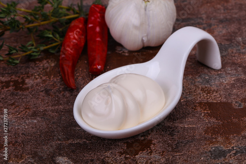 Mayonnaise sauce in the white bowl served thyme and garlic