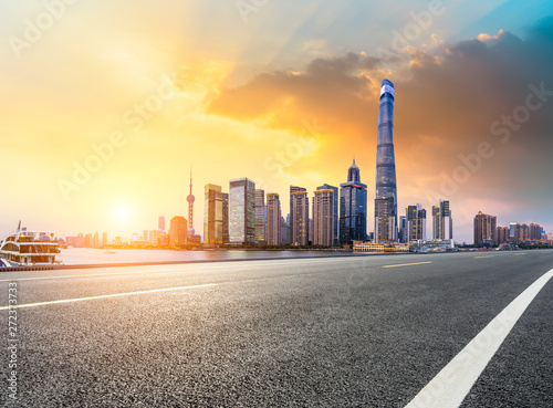 Shanghai skyline and modern city skyscrapers with empty road at sunset,China © ABCDstock