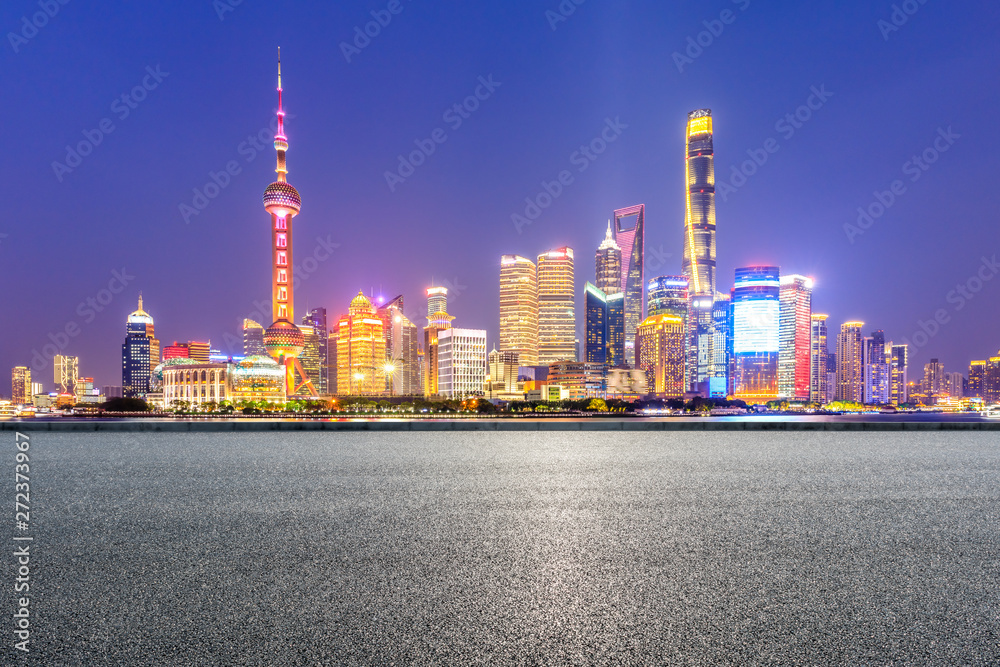 Shanghai skyline and modern city skyscrapers with empty road at night,China
