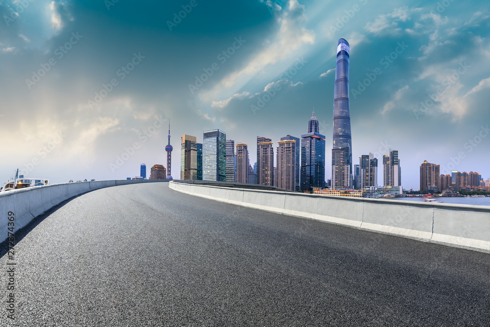 Shanghai skyline and modern city skyscrapers with empty road at sunset,China Shanghai skyline and modern city skyscrapers with empty road at sunset,China