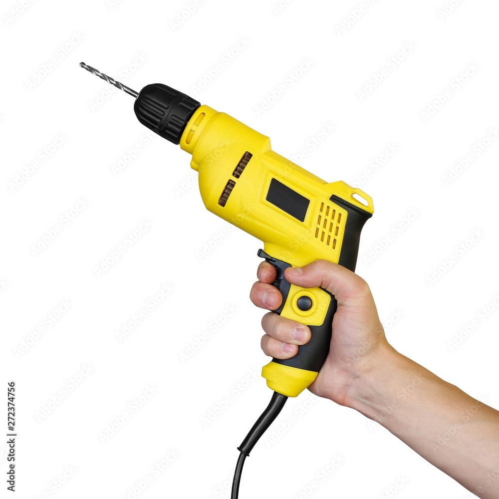 Hand holding a yellow electric drill. Close up. Isolated on white background Hand holding a yellow electric drill. Close up. Isolated on white background
