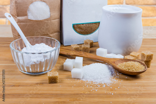 Konstfotografi White and brown sugar in different forms on wooden surface