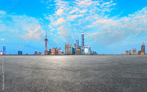 Asphalt race track ground and modern skyline and buildings in Shanghai at night panoramic view