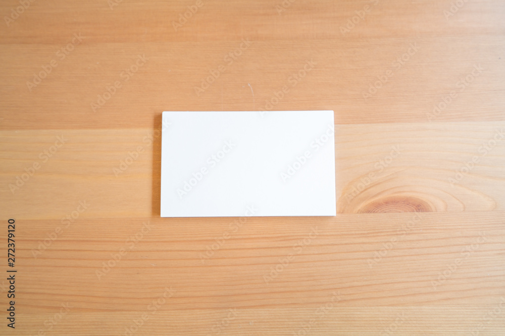 Blank business cards on wooden surface