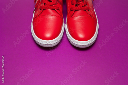 One sport red sneakers on purple background