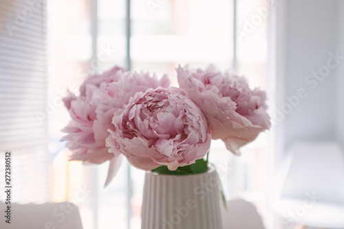 Pink peony flowers bouquet in bloom on an indoor decoration vase