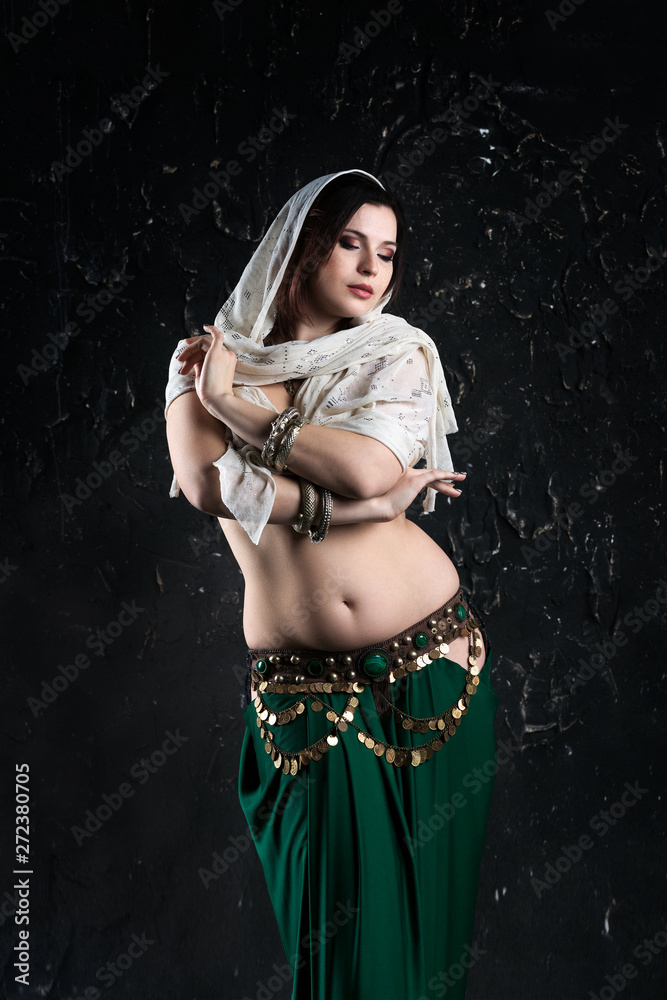 Sexy women performs belly dance in ethnic dress on black background,  abstract art photography Stock Photo | Adobe Stock