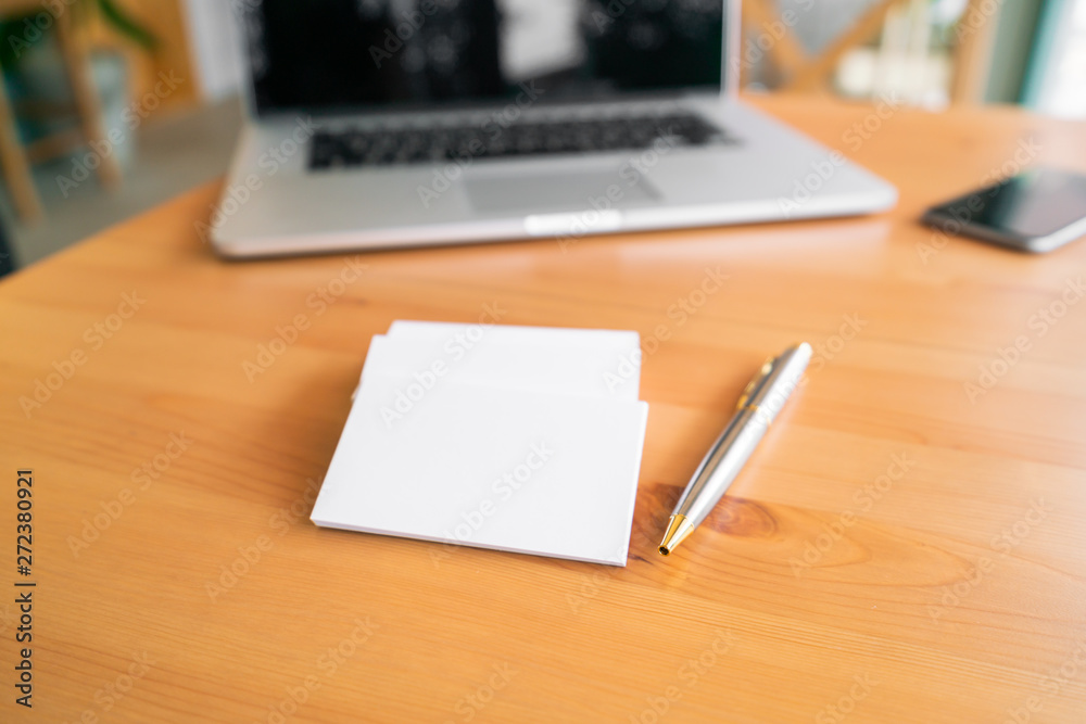 Blank business cards and laptop on wooden surface Blank business cards and laptop on wooden surface