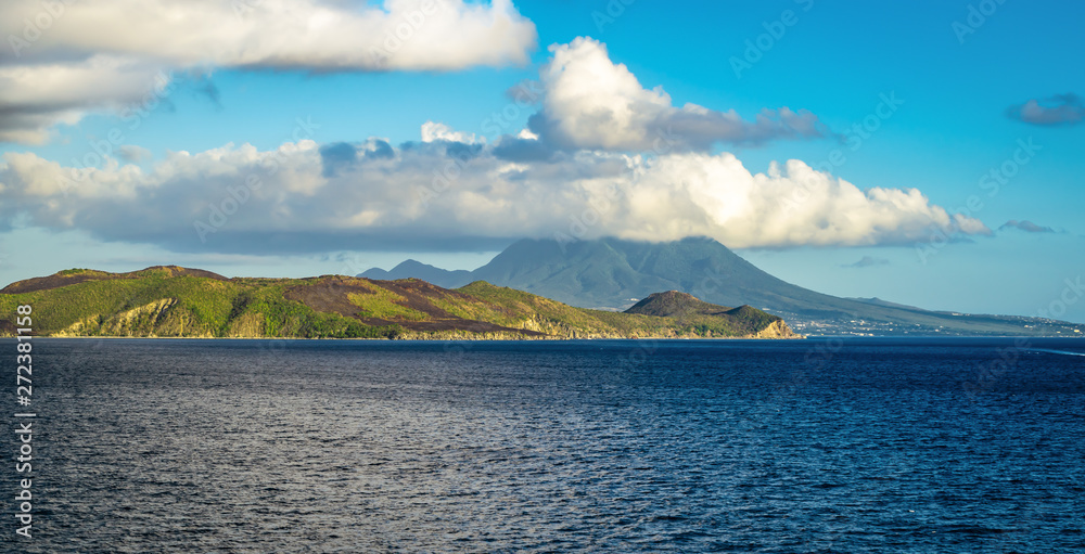 Nevis, Caribbean Island. Panorama landscape with mountain, sea, white clouds and blue sky.