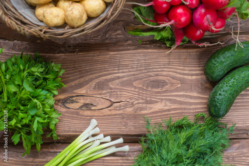 Frame on wooden background from fresh organic vegetables. A set of different vegetables.