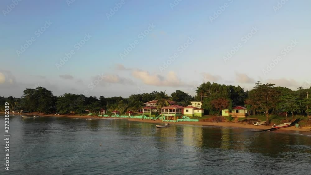 Aerial Lockdown: Island Village Houses On Shore Of Ocean - Little Corn Island, Nicaragua Aerial Lockdown: Island Village Houses On Shore Of Ocean - Little Corn Island, Nicaragua