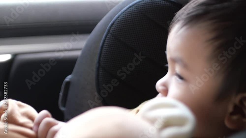 Baby boy sitting on car seat and go to travel 