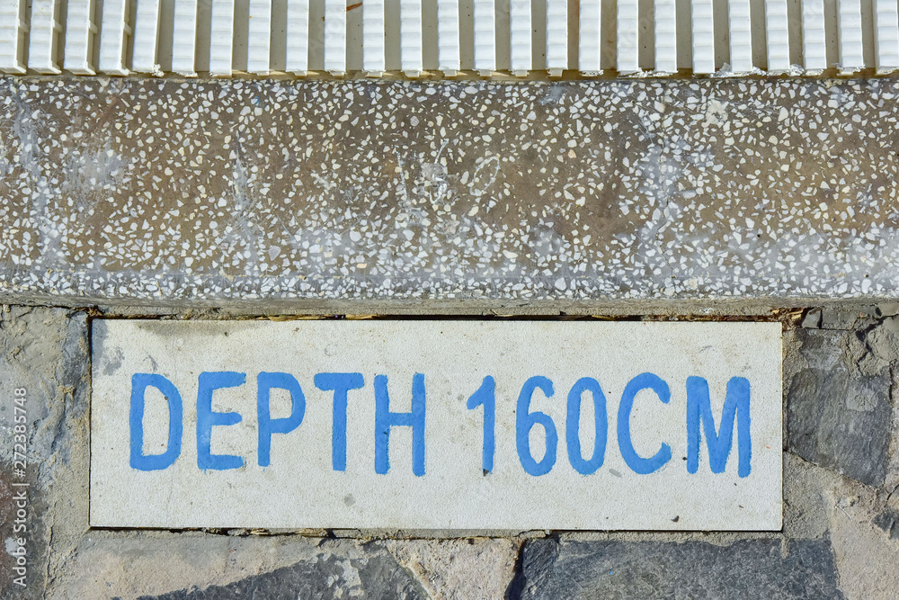information plate with an inscription on the side of the swimming pool DEEP 160 CM. safety at the hotel