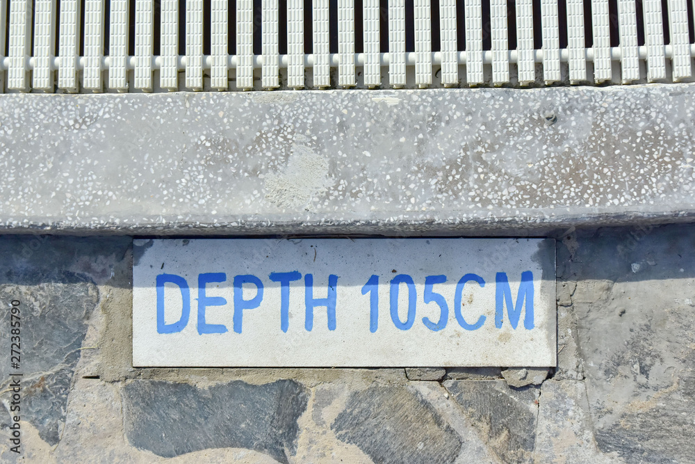information plate with an inscription on the side of a children's swimming pool DEPTH 105 CM. safety at the hotel