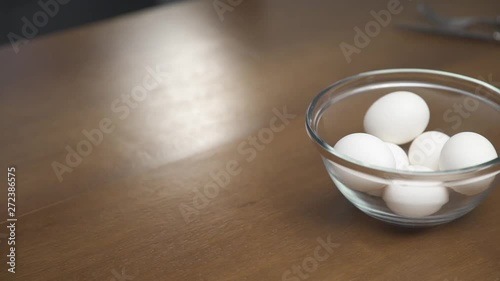 Female hands picking whites in a glass bowl. The image is in medium pan and shot. photo