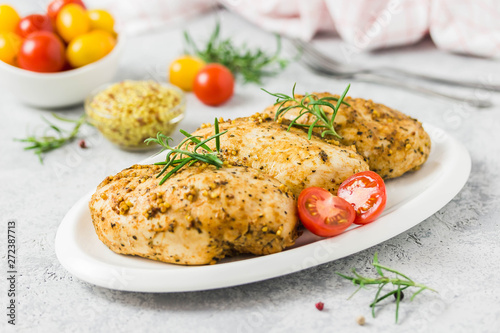 Baked mustard honey chicken breasts with cherry tomatoes. Selective focus, space for text.