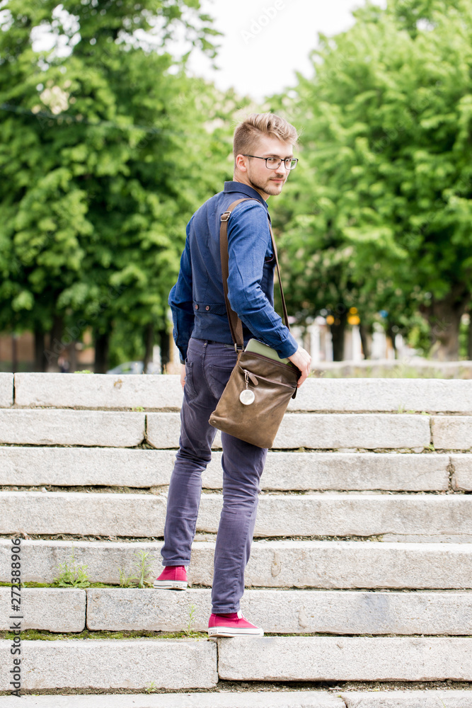 man goes up the stairs, back view