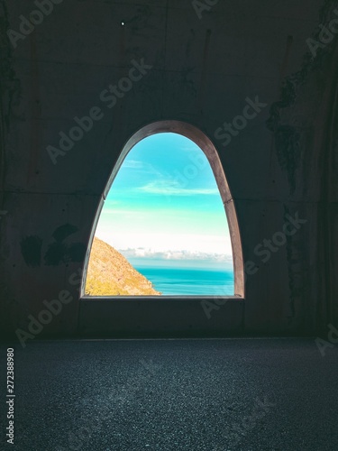 View out of a tunnel to the coastline. Serra de Tramuntana  Cap de Formentor  Mallorca  Spain