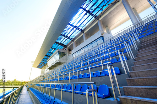 Blue plastic seats. Free arena seating. Empty plastic chairs seats for football fans. VIP lodge in the stadium. 
