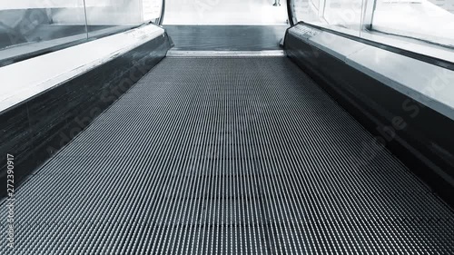 Close-up shot of empty moving staircase running up and down. Modern escalator stairs, which moves indoor.