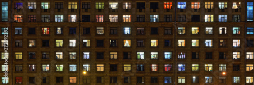 Panorama of the night Windows of the city apartment building photo