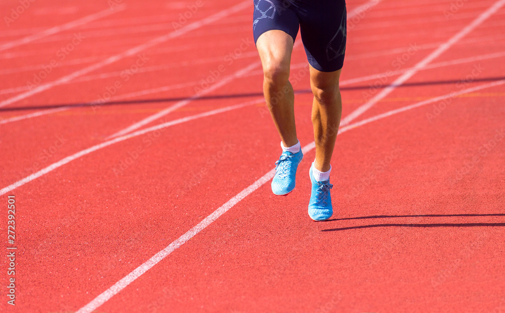 Young sporty man running on sunny day