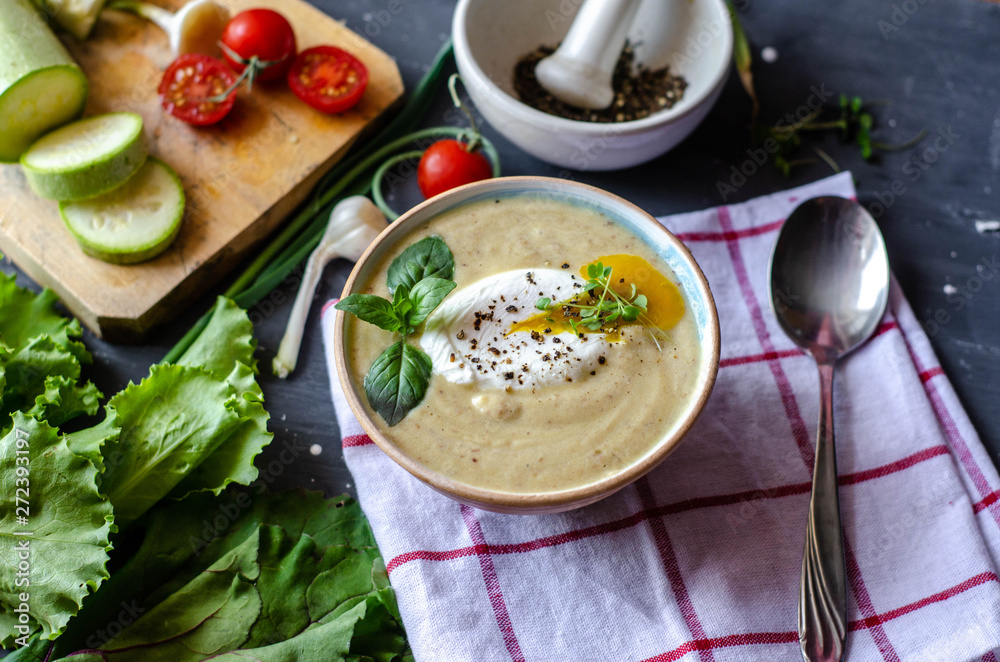 Healthy zucchini cream soup served with poached egg and greens. Proper nutrition food Healthy zucchini cream soup served with poached egg and greens. Proper nutrition food