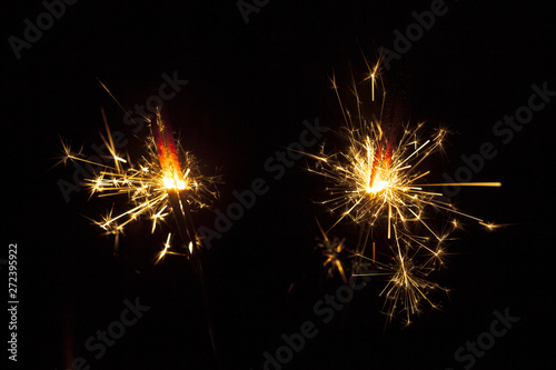 Dark background with two sparklers