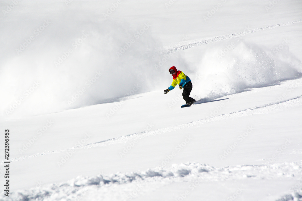 Snowboarder in fine white powder snow