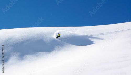 Snowboarder in fine white powder snow