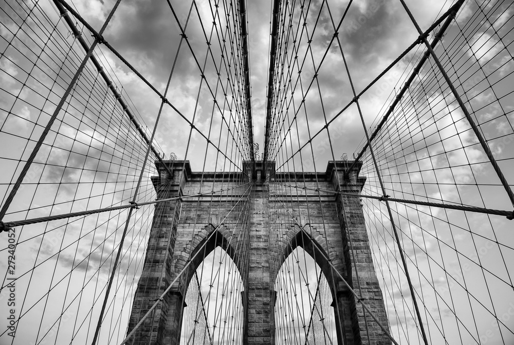 Brooklyn Bridge New York City close up architectural detail in timeless black and white under soft overcast skies - obrazy, fototapety, plakaty 