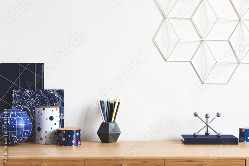 Εκτύπωση καμβά Cosmic and stylish home office interior with wooden desk, cool office accessories, tapes, supplies, notebooks, memo sticks, pencils