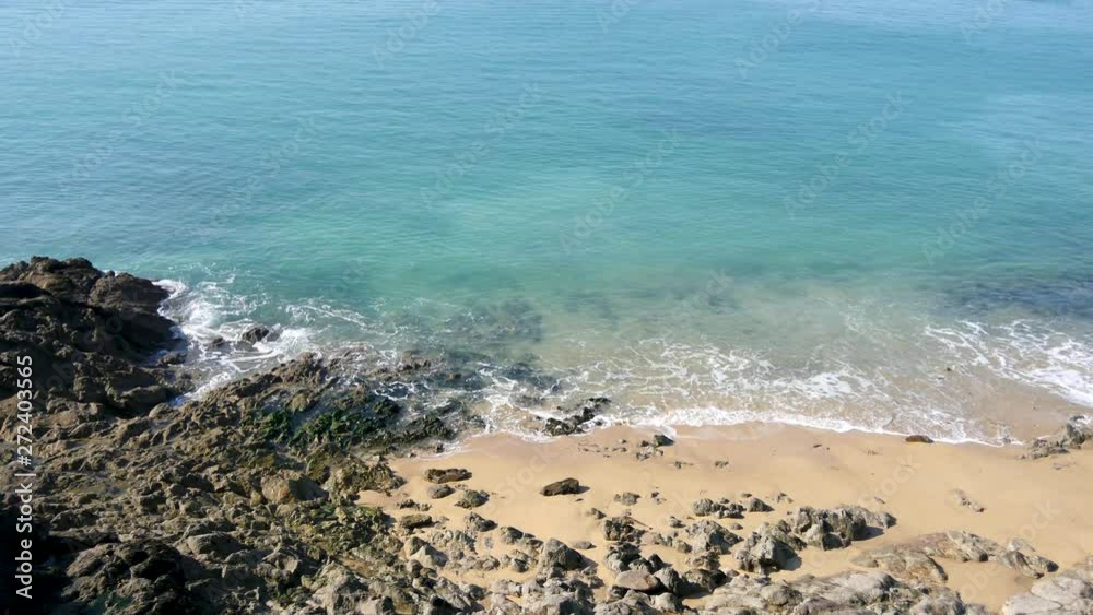 View on a beach in the city of Saint-Malo, in Brittany, in the west of France. Sunny day. There are rocks and sand. View on a beach in the city of Saint-Malo, in Brittany, in the west of France. Sunny day. There are rocks and sand.