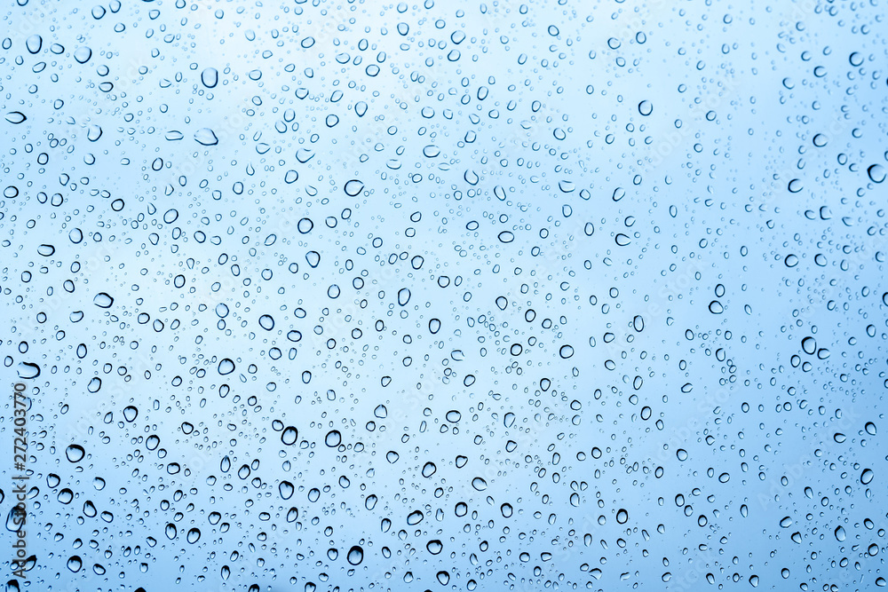 Close up view of water drops falling on glass. Rain running down on window. Rainy season, autumn. Raindrops trickle down, grey sky. Close up view of water drops falling on glass. Rain running down on window. Rainy season, autumn. Raindrops trickle down, grey sky.