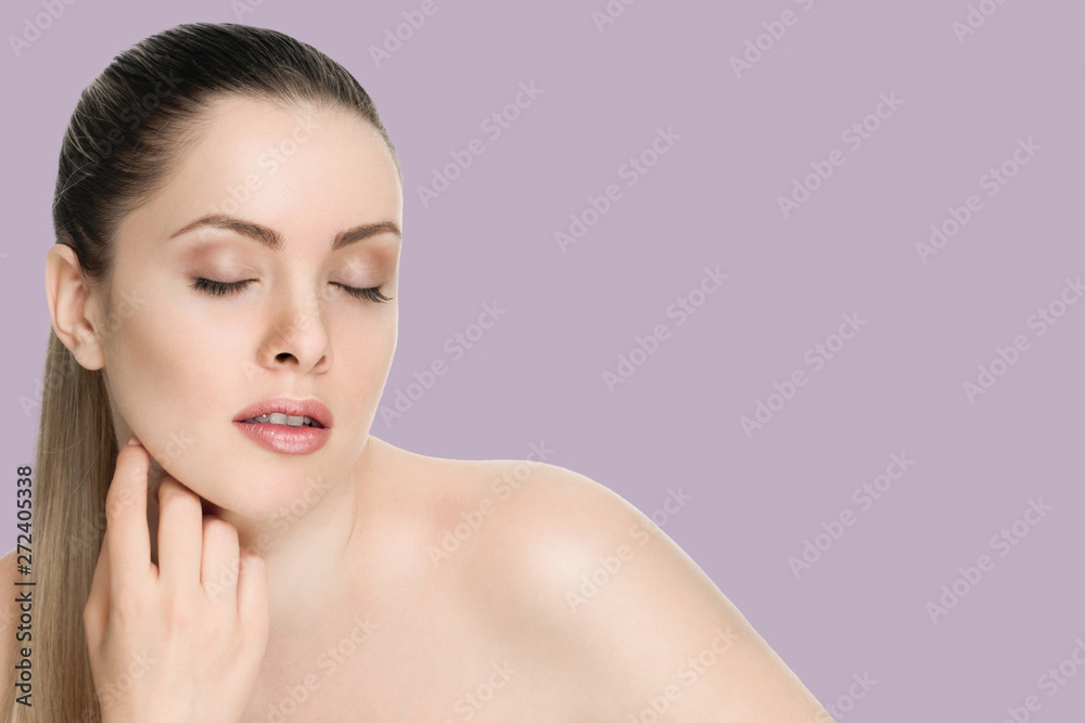 Beautiful face of a woman with clean skin - on background thistle shade violet Beautiful face of a woman with clean skin - on background thistle shade violet