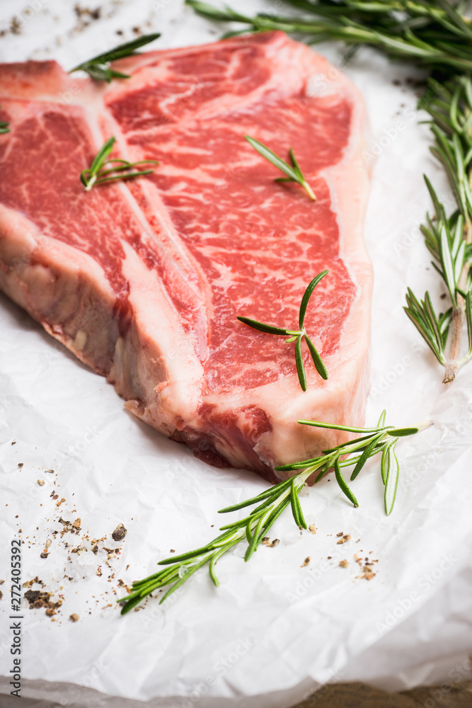 Raw fresh marble T-bone meat on the rustic background. Selective focus. Shallow depth of field. Raw fresh marble T-bone meat on the rustic background. Selective focus. Shallow depth of field.