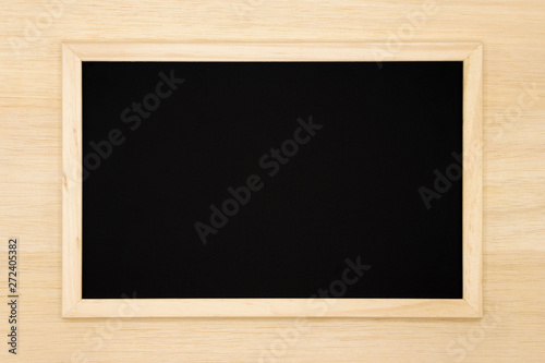 Blank chalkboard on wooden background. 